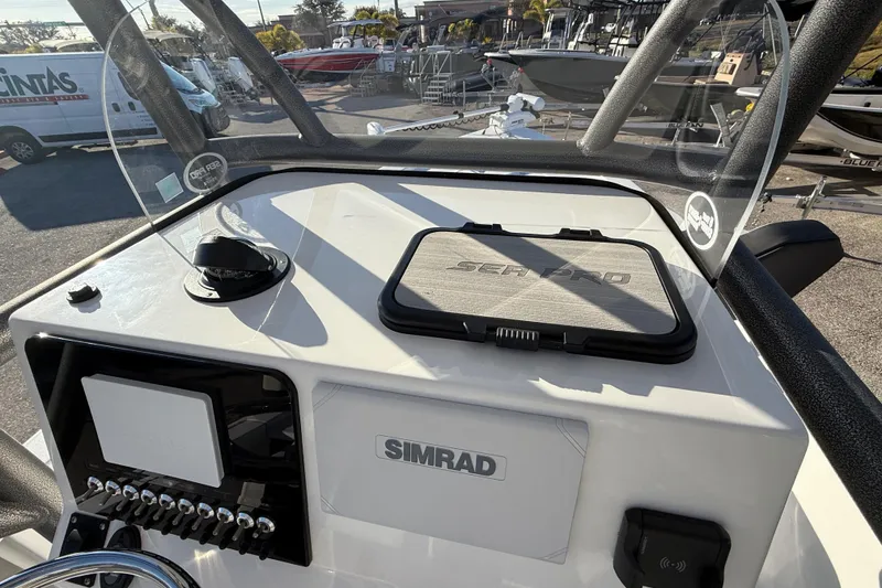 Slide: The Image of 2025 Sea Pro 230 Bay boat dashboard with Simrad electronics and controls. - 21