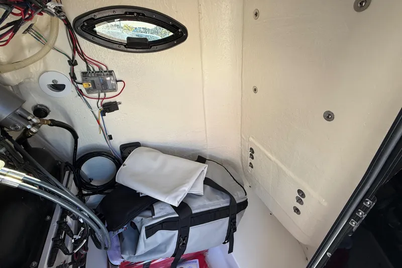 Slide: The Image of Interior view of 2025 Sea Pro 230 Bay boat with storage and wiring. - 22