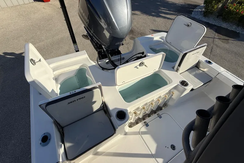 Slide: The Image of 2025 Sea Pro 230 Bay boat with open storage compartments and Yamaha outboard motor. - 23