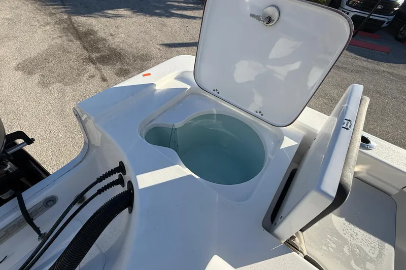 Slide: The Image of Open livewell on 2025 Sea Pro 230 Bay boat, showcasing interior water storage. - 26
