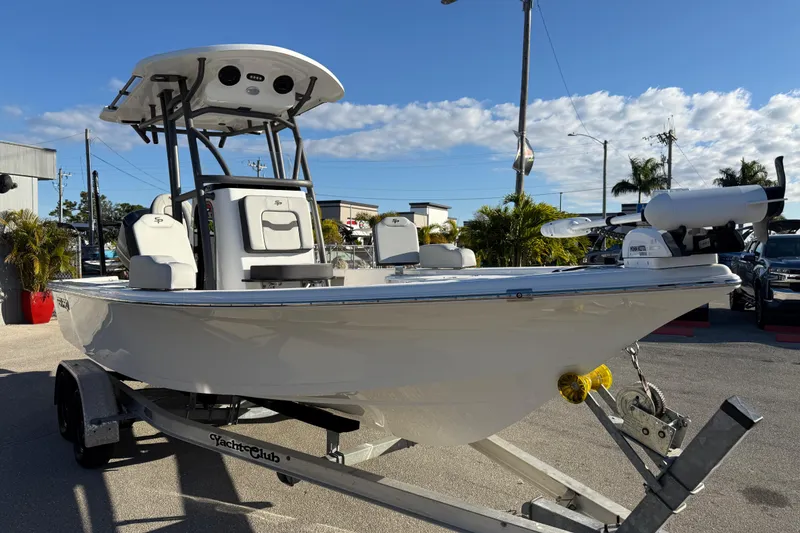 Slide: The Image of 2025 Sea Pro 230 Bay boat on trailer, sunny day, dealership background. - 4