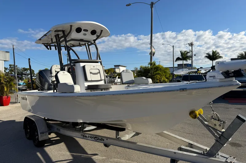 Slide: The Image of 2025 Sea Pro 230 Bay boat on trailer, sunny day, palm trees in background. - 5