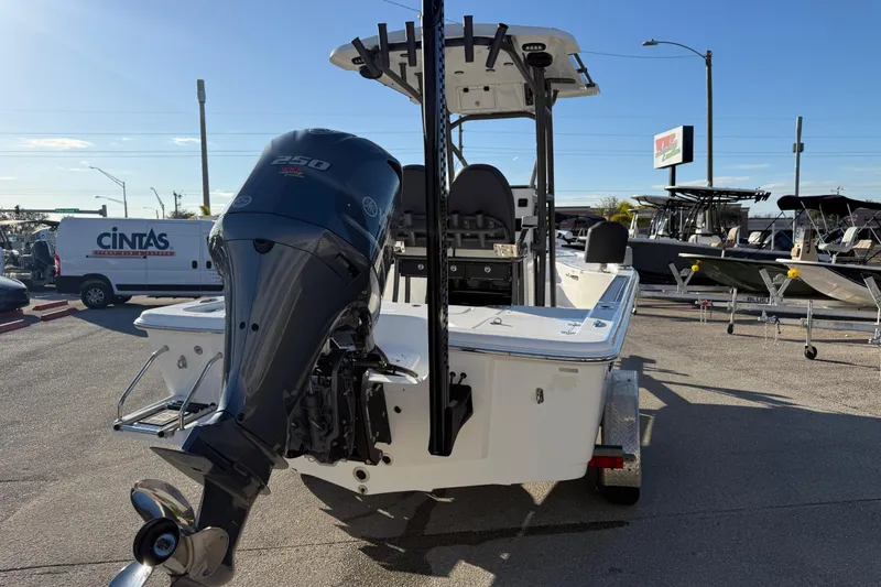 Slide: The Image of 2025 Sea Pro 230 Bay boat with powerful outboard motor in a dealership lot. - 7
