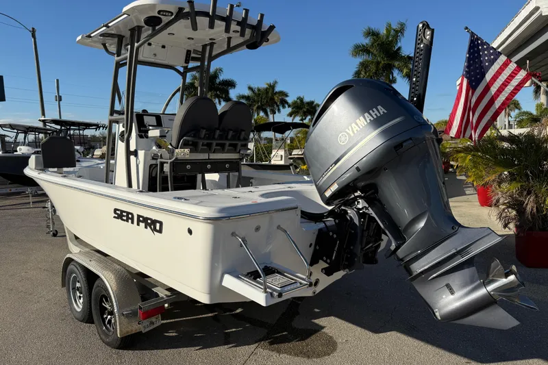 Slide: The Image of 2025 Sea Pro 230 Bay boat with Yamaha engine, parked on a trailer. - 8