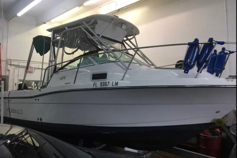 The Image of 2001 Robalo 2440 Walkaround boat in indoor storage, side view. - 0