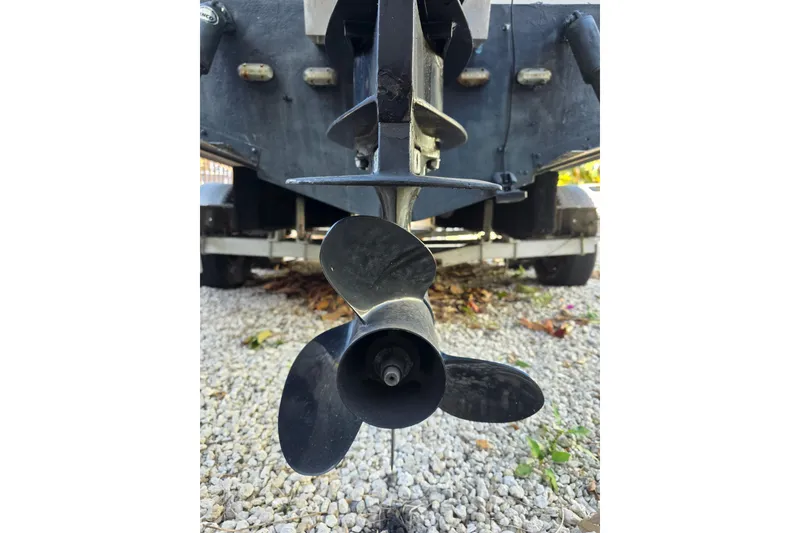 Slide: The Image of Propeller of 2001 Robalo 2440 Walkaround boat on gravel surface. - 10