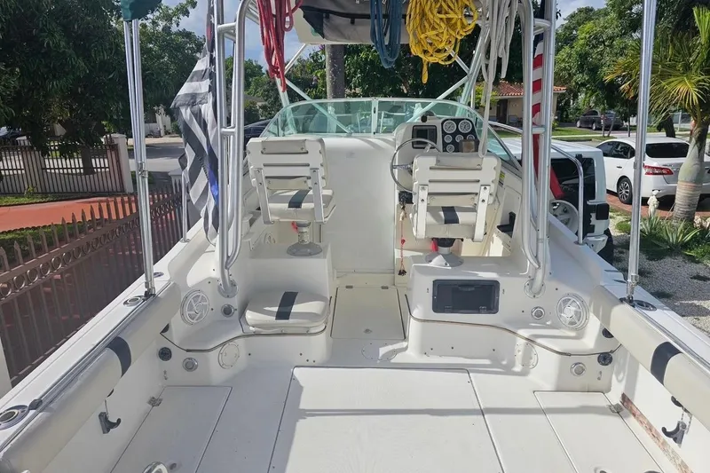 Slide: The Image of 2001 Robalo 2440 Walkaround boat interior with seating and control panel. - 2