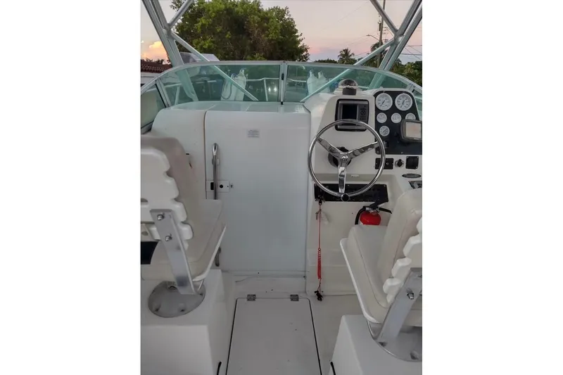 Slide: The Image of 2001 Robalo 2440 Walkaround boat cockpit with steering wheel and gauges. - 3