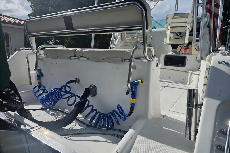Slide: The Image of 2001 Robalo 2440 Walkaround boat interior with seating and coiled hoses. - 5