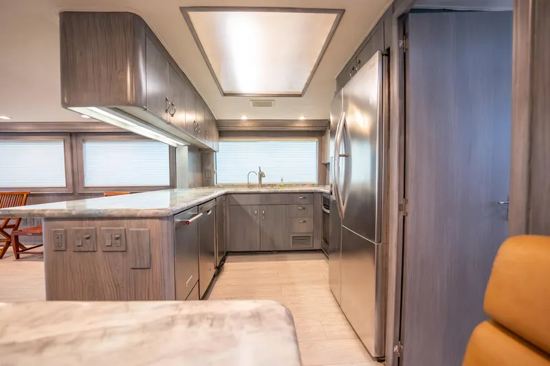 Slide: The Image of Luxurious kitchen interior of 1998 Hatteras 74 Cockpit Motor Yacht with modern appliances. - 10