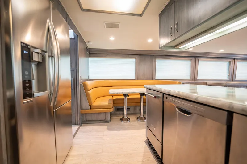Slide: The Image of Luxurious kitchen interior of 1998 Hatteras 74 Cockpit Motor Yacht with modern appliances and seating. - 11