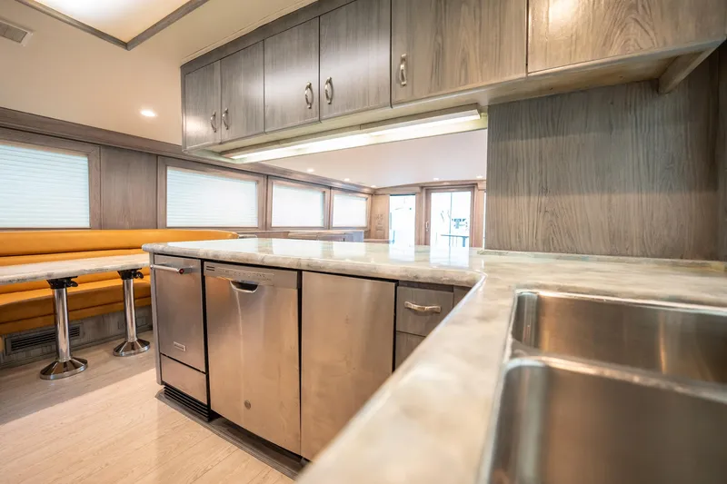 Slide: The Image of Interior of 1998 Hatteras 74 Cockpit Motor Yacht with modern kitchen and dining area. - 12