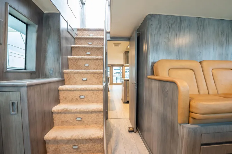 Slide: The Image of Interior of 1998 Hatteras 74 Cockpit Motor Yacht with stairs and seating area. - 15