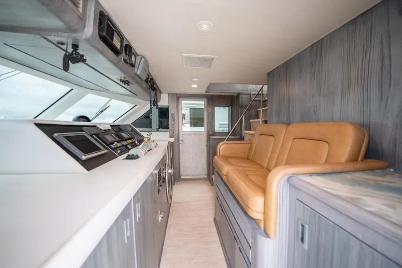 Slide: The Image of Interior of 1998 Hatteras 74 Cockpit Motor Yacht with leather seating and control panel. - 16