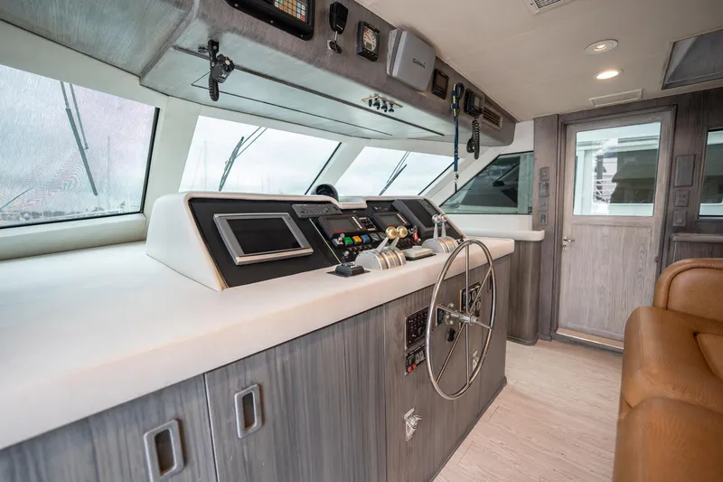 Slide: The Image of Interior helm of 1998 Hatteras 74 Cockpit Motor Yacht with modern controls and steering wheel. - 17