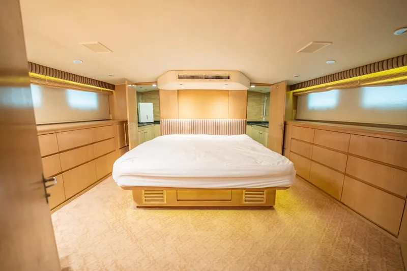 Slide: The Image of Luxurious bedroom interior of 1998 Hatteras 74 Cockpit Motor Yacht with elegant wood finish. - 22