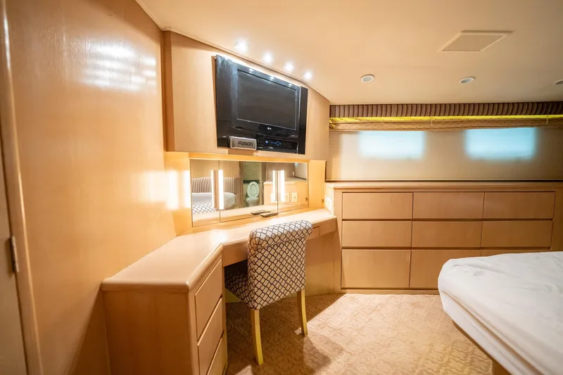 Slide: The Image of Luxurious cabin interior of 1998 Hatteras 74 Cockpit Motor Yacht with desk and TV. - 23