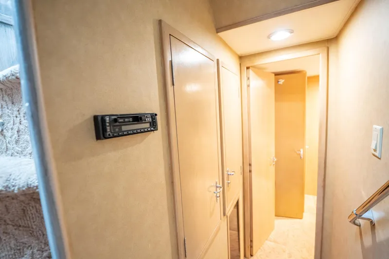 Slide: The Image of Interior hallway of 1998 Hatteras 74 Cockpit Motor Yacht with wood paneling and lighting. - 28