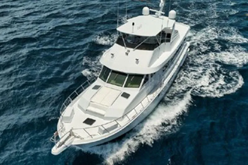 Slide: The Image of 1998 Hatteras 74 Cockpit Motor Yacht cruising on open sea. - 3