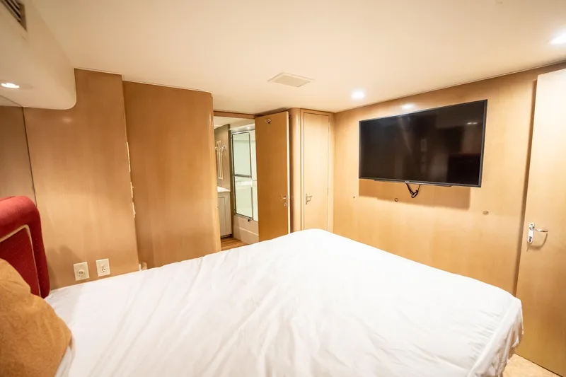 Slide: The Image of Bedroom interior of 1998 Hatteras 74 Cockpit Motor Yacht with TV and ensuite bathroom. - 31