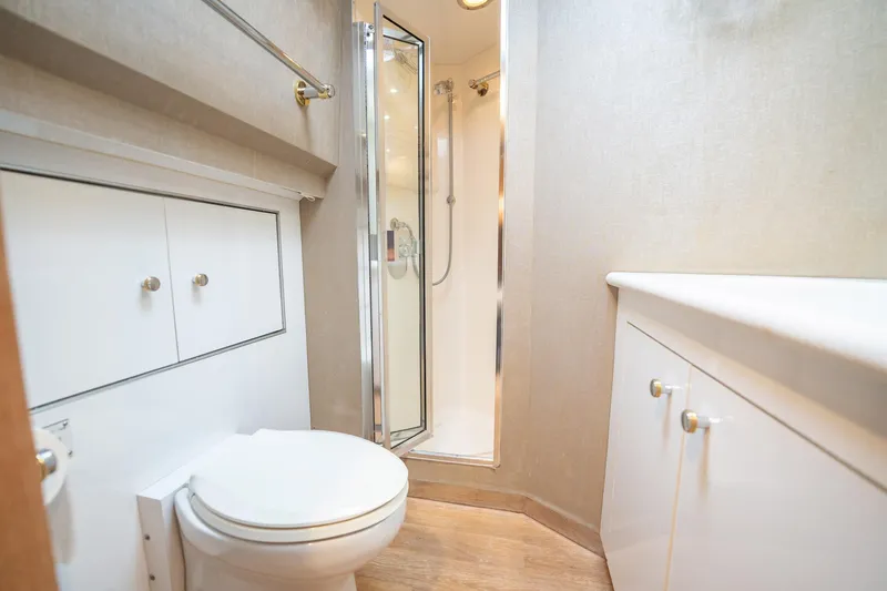 Slide: The Image of Bathroom interior of 1998 Hatteras 74 Cockpit Motor Yacht, featuring shower and toilet. - 36