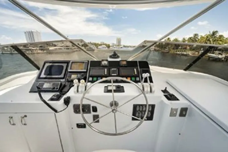 Slide: The Image of Cockpit view of 1998 Hatteras 74 Cockpit Motor Yacht with steering wheel and navigation controls. - 44