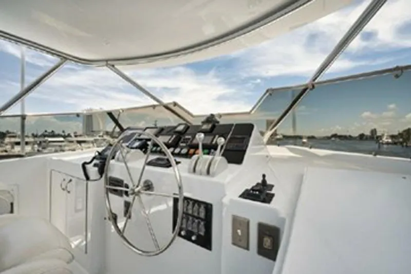 Slide: The Image of Helm of 1998 Hatteras 74 Cockpit Motor Yacht with steering wheel and controls. - 45