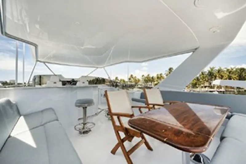 Slide: The Image of Luxurious 1998 Hatteras 74 Cockpit Motor Yacht with elegant outdoor seating and table. - 47