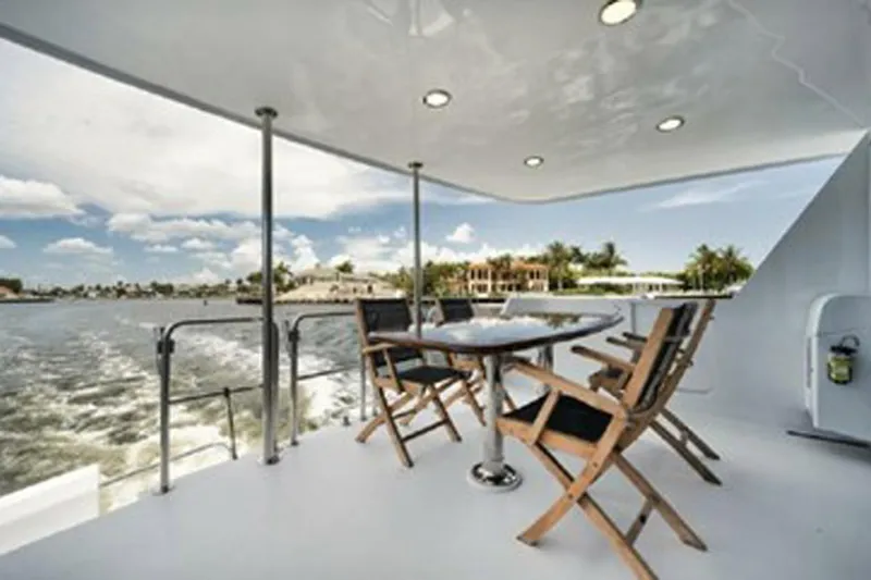 Slide: The Image of Outdoor seating on 1998 Hatteras 74 Cockpit Motor Yacht, with ocean view and clear skies. - 51