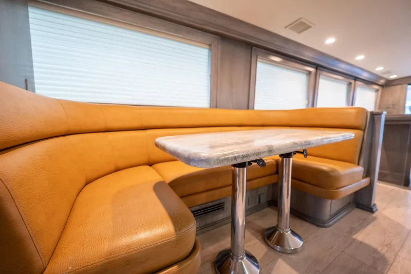 Slide: The Image of Luxurious interior of 1998 Hatteras 74 Cockpit Motor Yacht with elegant seating and table. - 9