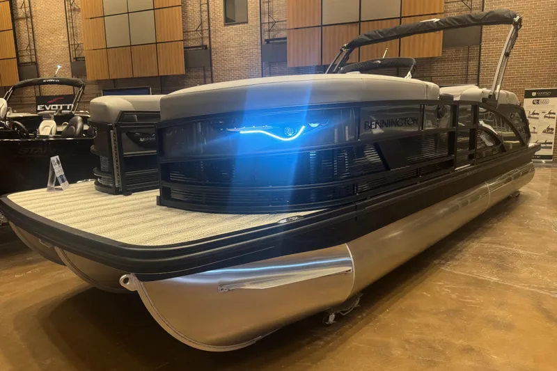 The Image of 2026 Bennington 24 M Swingback pontoon boat displayed indoors with sleek design and modern features. - 0