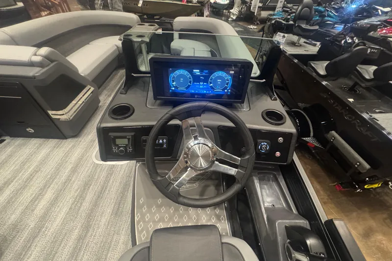 Slide: The Image of 2026 Bennington 24 M Swingback boat interior with modern dashboard and steering wheel. - 11
