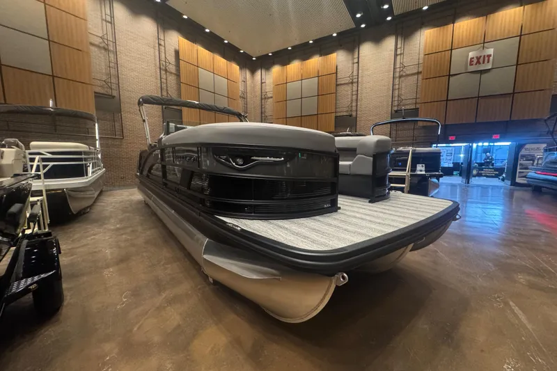 Slide: The Image of 2026 Bennington 24 M Swingback pontoon boat displayed indoors with modern design. - 2