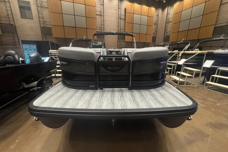 Slide: The Image of 2026 Bennington 24 M Swingback pontoon boat displayed indoors, showcasing sleek design. - 4