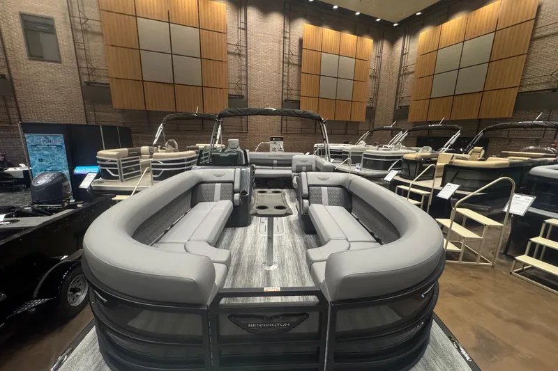 Slide: The Image of 2026 Bennington 24 M Swingback pontoon boat displayed indoors, featuring luxurious seating and modern design. - 5