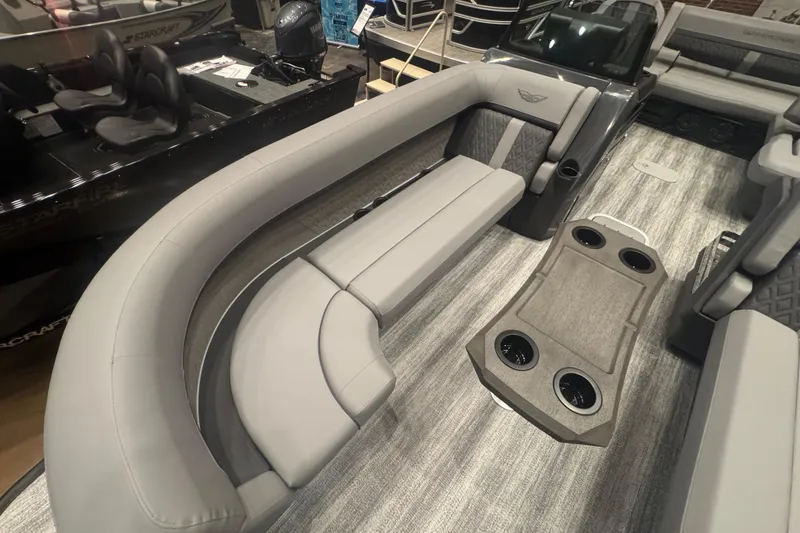 Slide: The Image of 2026 Bennington 24 M Swingback pontoon boat interior with gray seating and cup holders. - 7