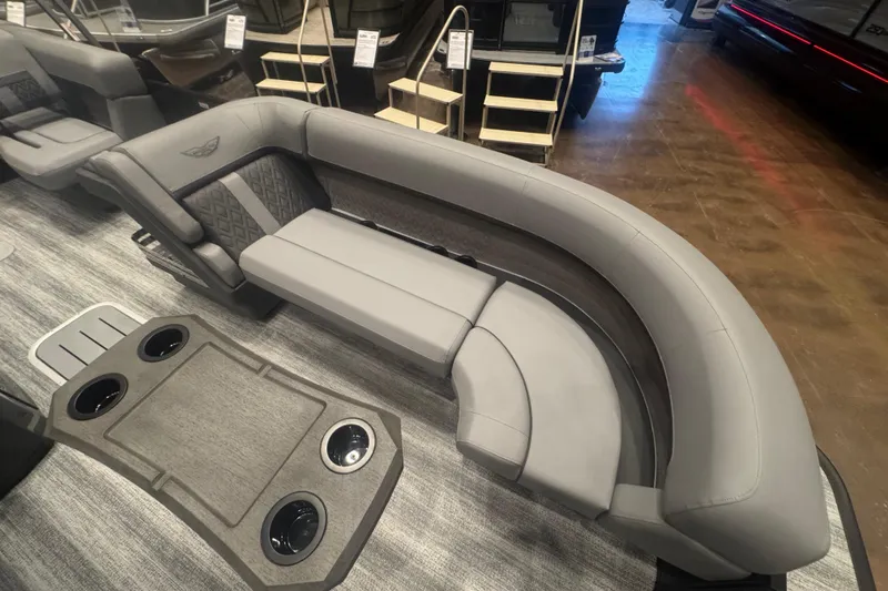 Slide: The Image of 2026 Bennington 24 M Swingback boat interior with luxurious gray seating and cup holders. - 8