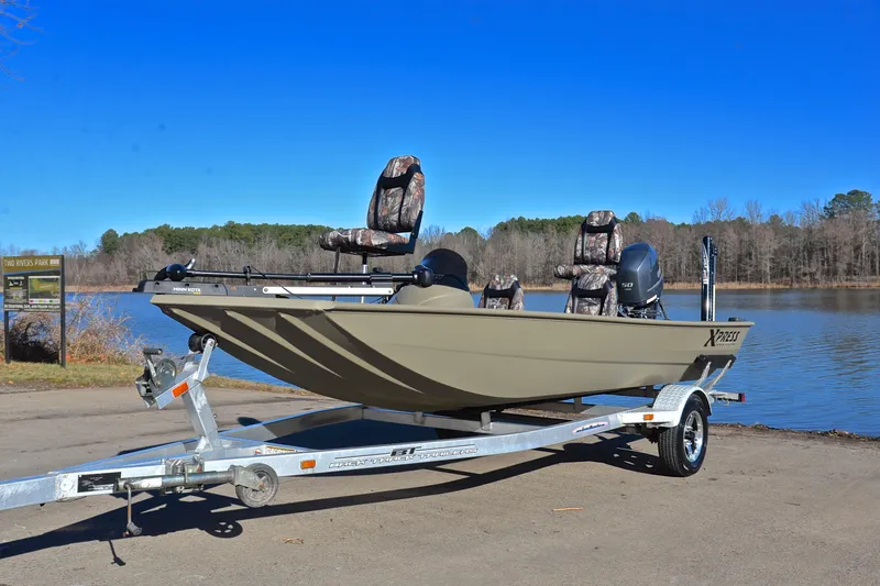 Slide: The Image of 2013 Express Xp170 boat on trailer by lake, clear blue sky background. - 10