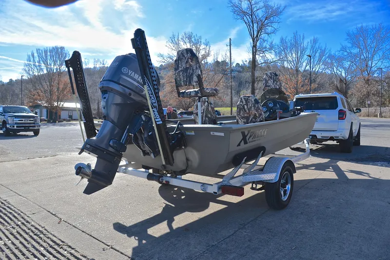 Slide: The Image of 2013 Express Xp170 boat on trailer with Yamaha outboard motor in parking lot. - 14