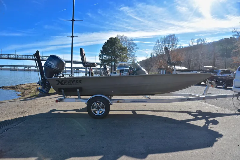 Slide: The Image of 2013 Express Xp170 boat on trailer by a scenic lakeside. - 15