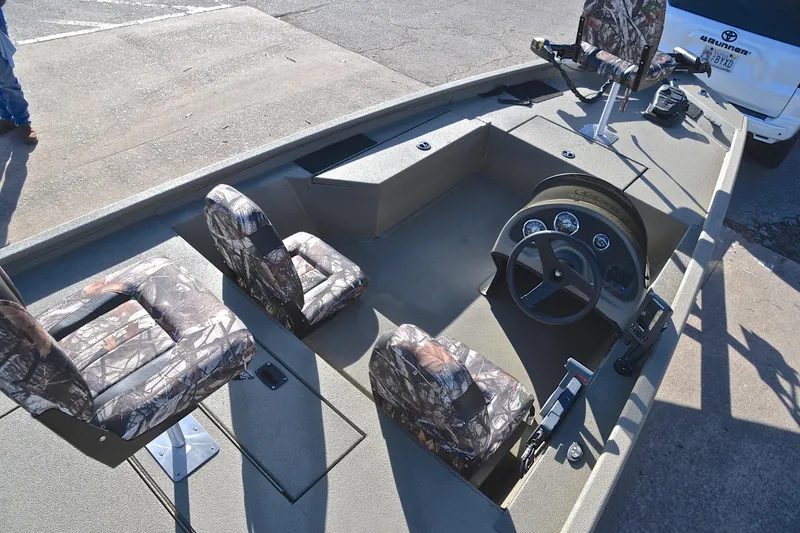 Slide: The Image of 2013 Express Xp170 boat interior with camouflage seats and steering console. - 20