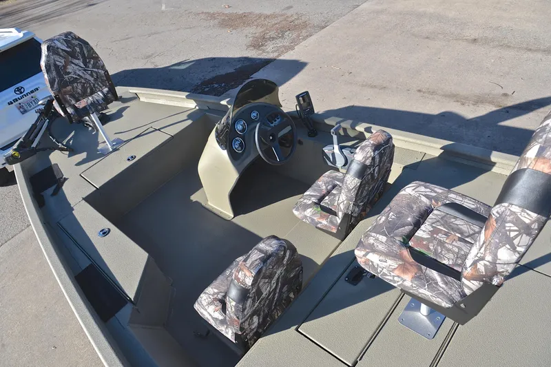 Slide: The Image of 2013 Express Xp170 boat interior with camouflage seats and steering console. - 21