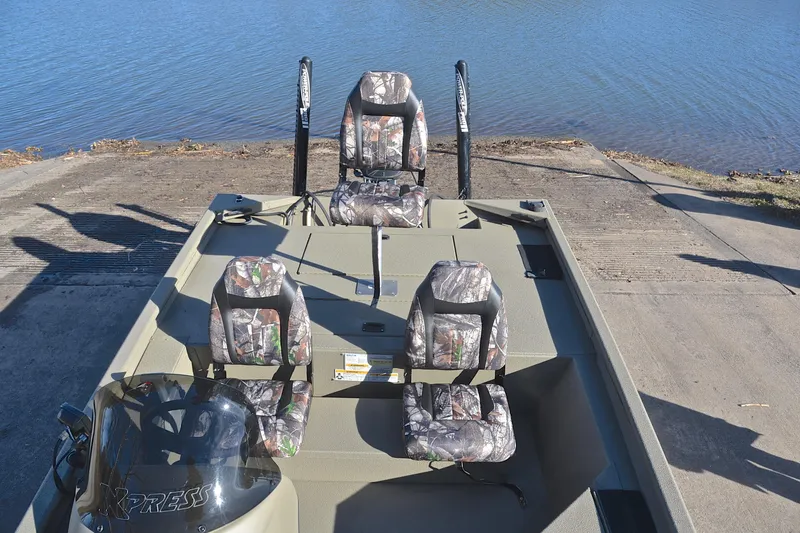 Slide: The Image of 2013 Express Xp170 boat with camouflage seats near a lake. - 22