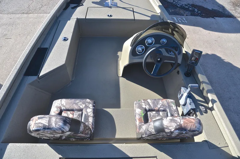 Slide: The Image of 2013 Express Xp170 boat interior with camouflage seats and steering console. - 23