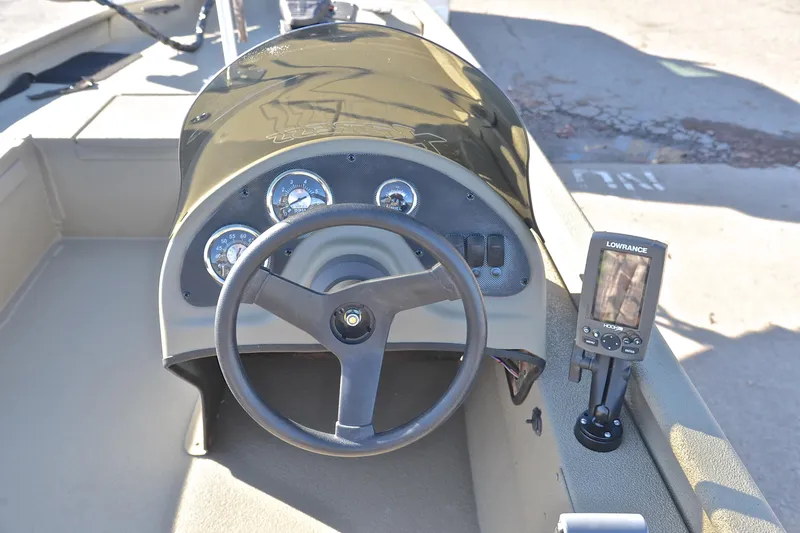 Slide: The Image of 2013 Express Xp170 boat dashboard with steering wheel and Lowrance fish finder. - 24