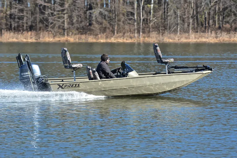 Slide: The Image of 2013 Express Xp170 boat cruising on a lake with a Yamaha motor. - 3