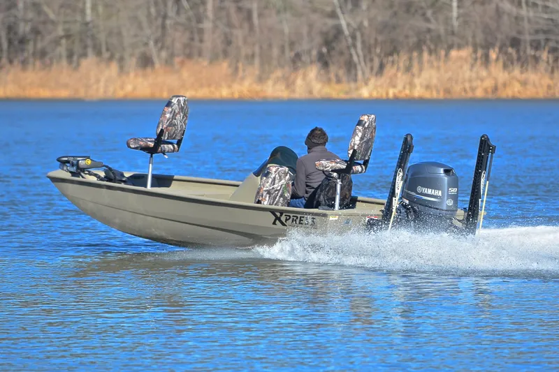 Slide: The Image of 2013 Express Xp170 boat with Yamaha motor cruising on a lake. - 4