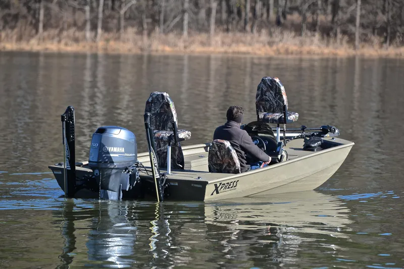 Slide: The Image of Man driving 2013 Express Xp170 boat with Yamaha motor on a calm lake. - 8