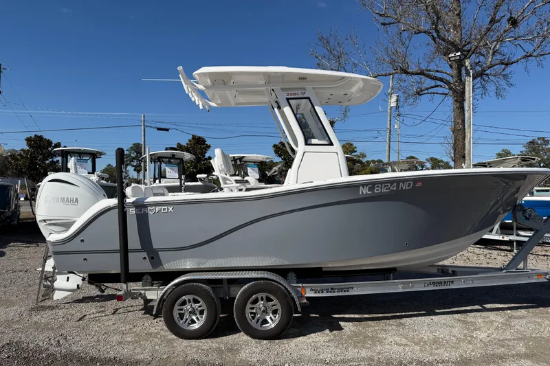 The Image of 2025 Sea Fox 228 Commander boat on trailer, side view, clear sky background. - 0