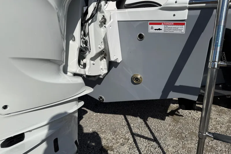 Slide: The Image of 2025 Sea Fox 228 Commander boat stern detail with warning label and ladder. - 11